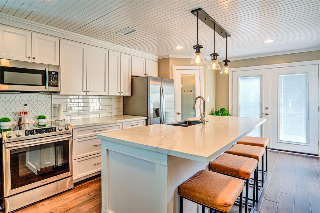 This is the heart of the home. Light and bright, this kitchen boasts quartz countertops, a breakfast bar and a walk-in pantry. Fridge is included