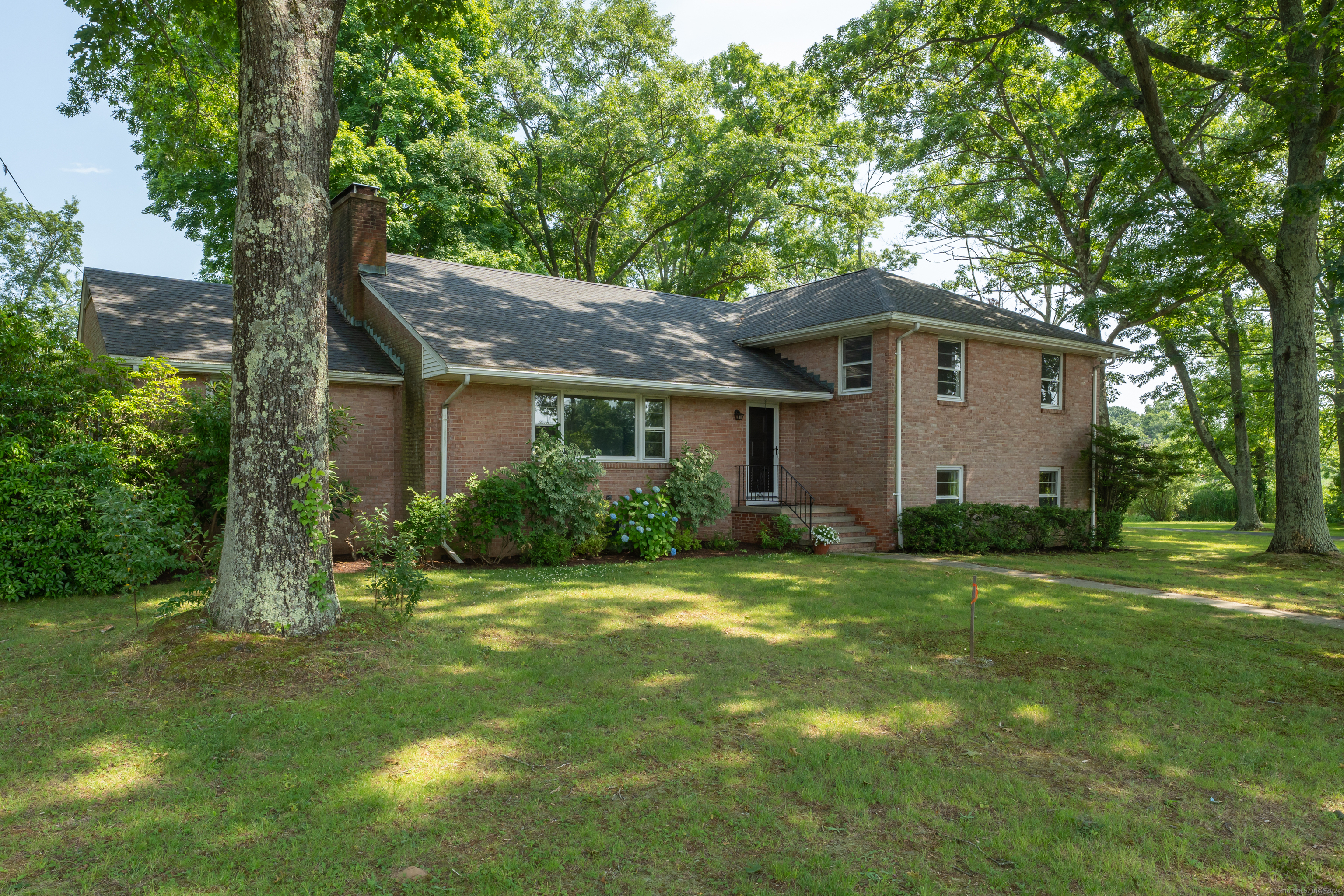 a front view of a house with a garden