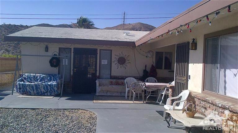 a view of a patio with a dining table and chairs