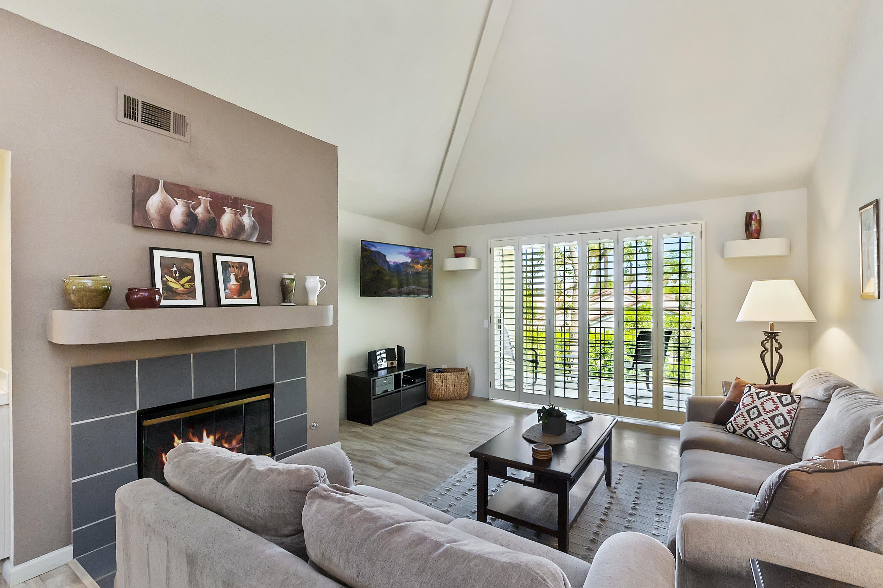 a living room with furniture window and a fireplace