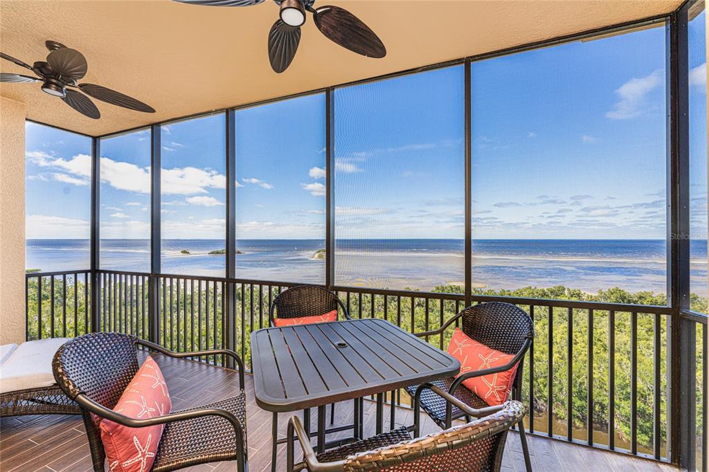 a balcony with table and chairs