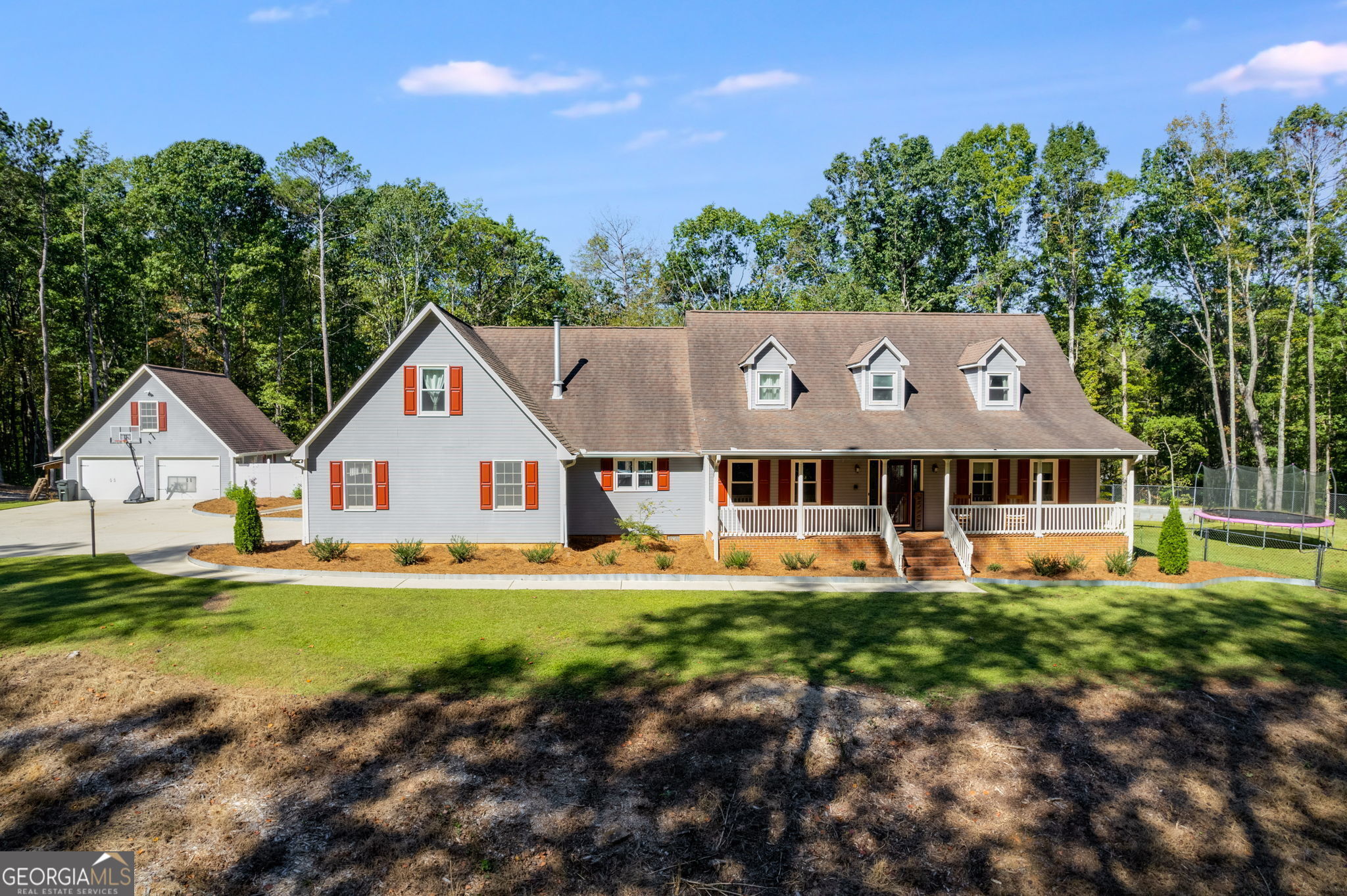 a view of a house with a yard and sitting area