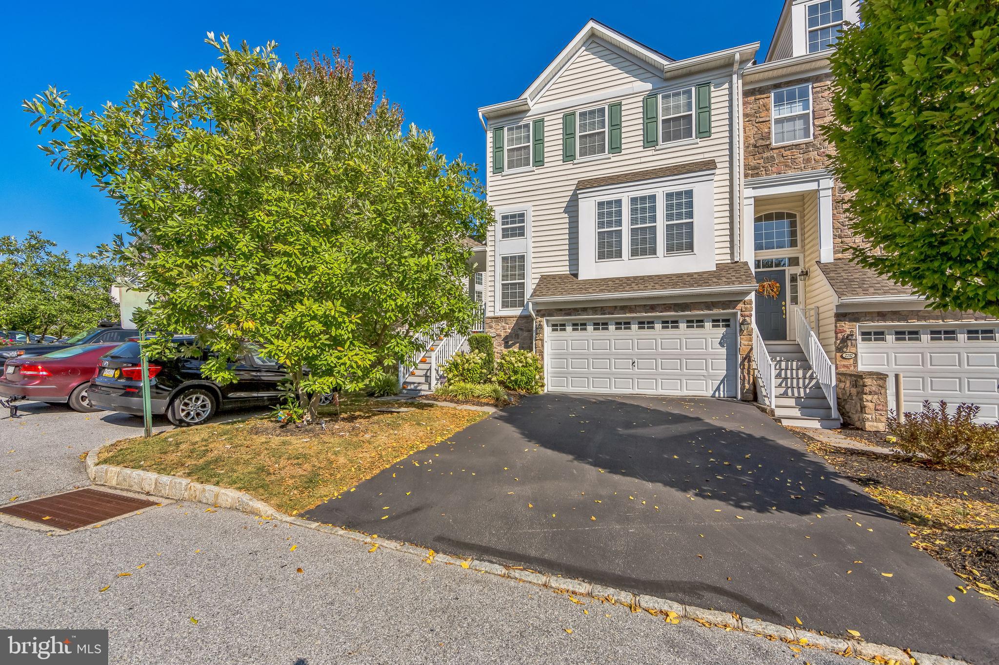 a view of a house with a yard and garage