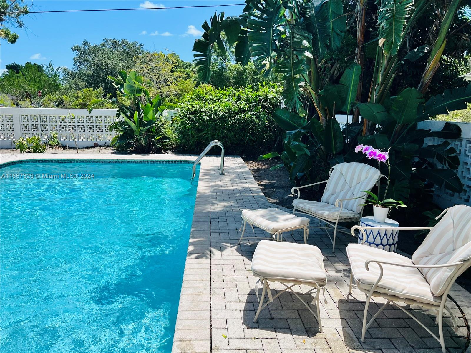 a view of backyard with outdoor seating and green space