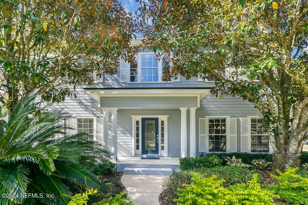 front view of a house with a tree