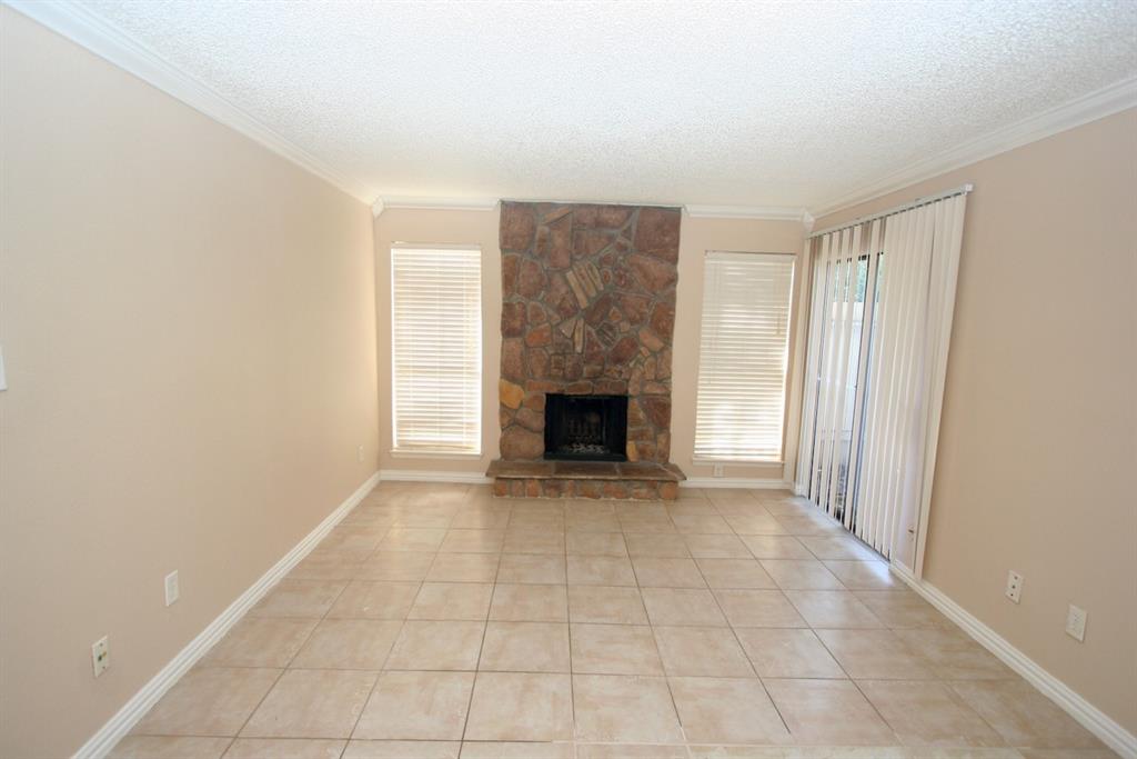 an empty room with a fireplace and a window