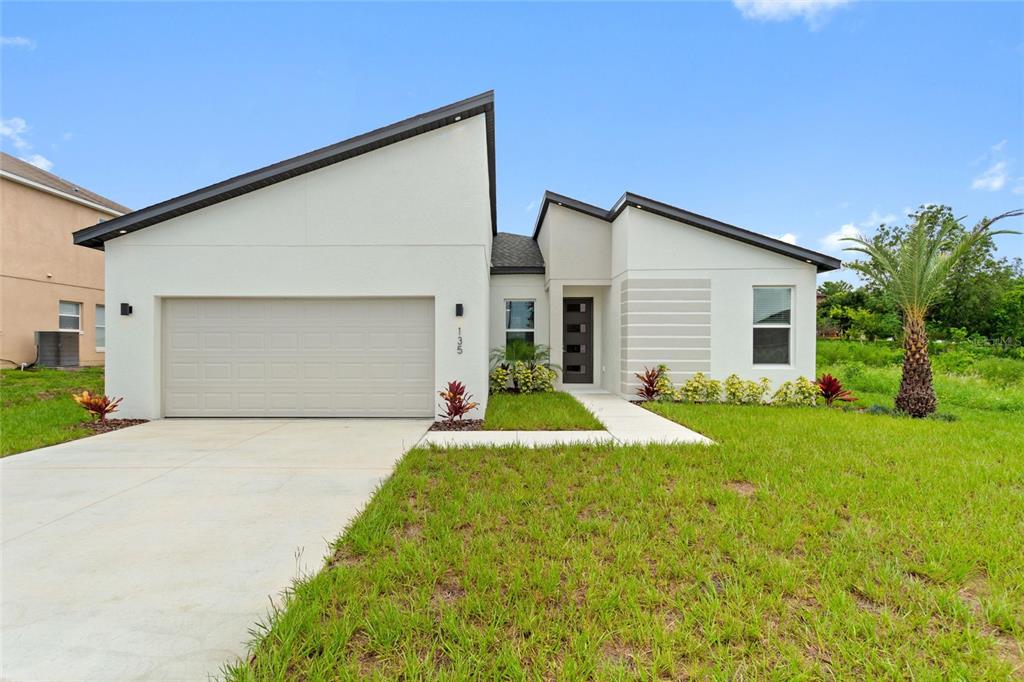 a view of backyard of house with outdoor seating and green space