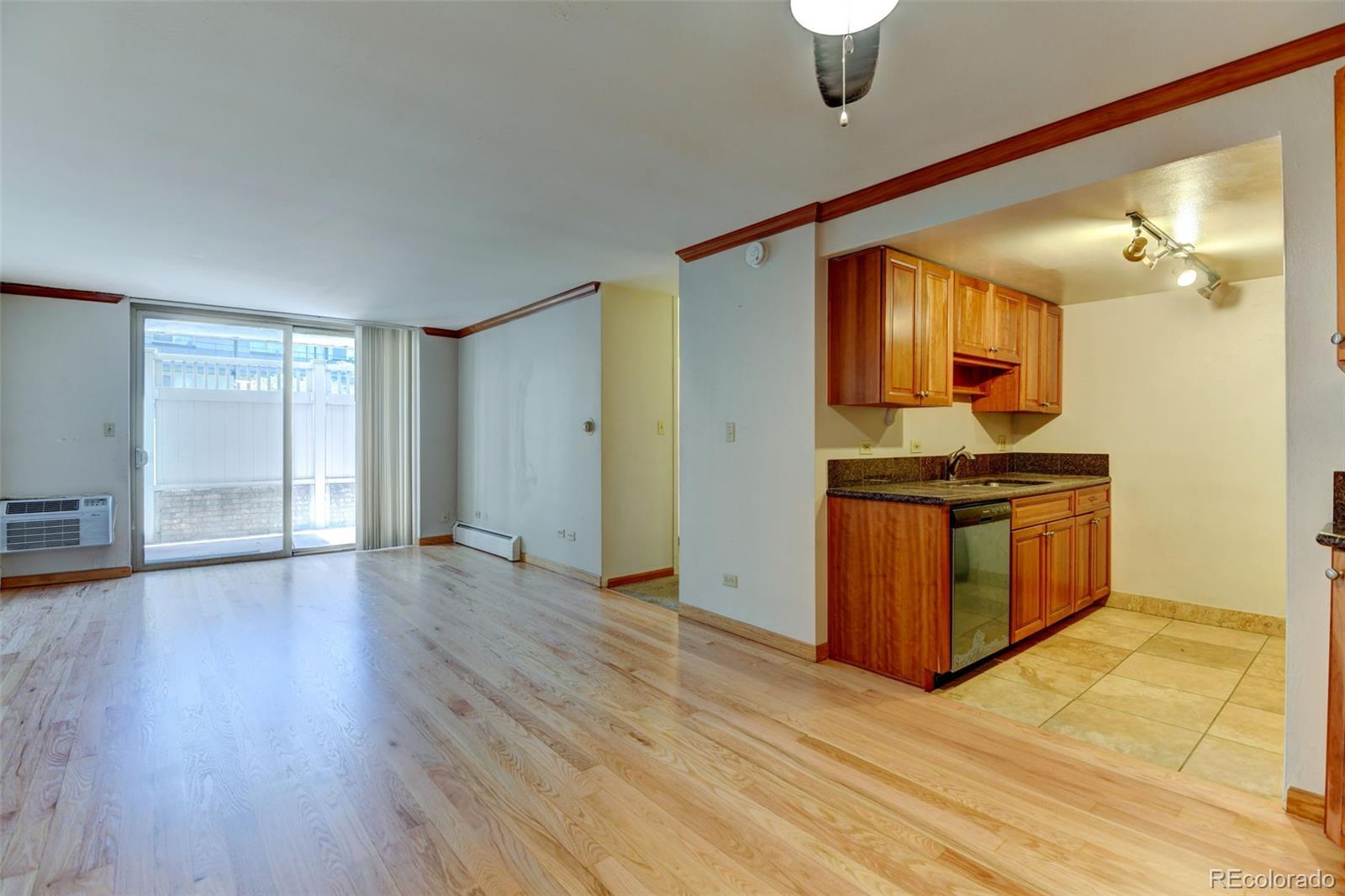 a kitchen with granite countertop a stove and a wooden floors