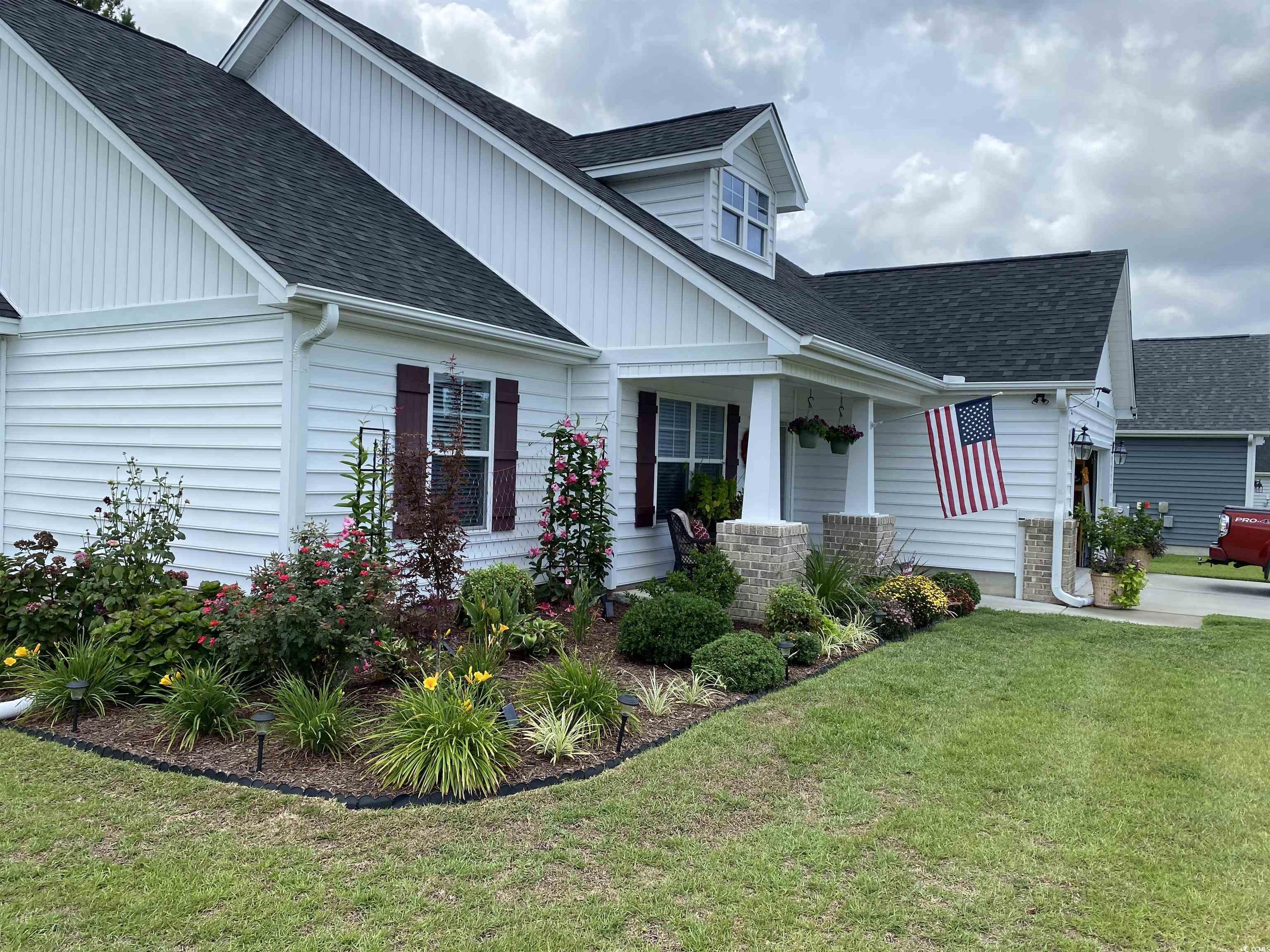 View of front of house featuring central AC unit a