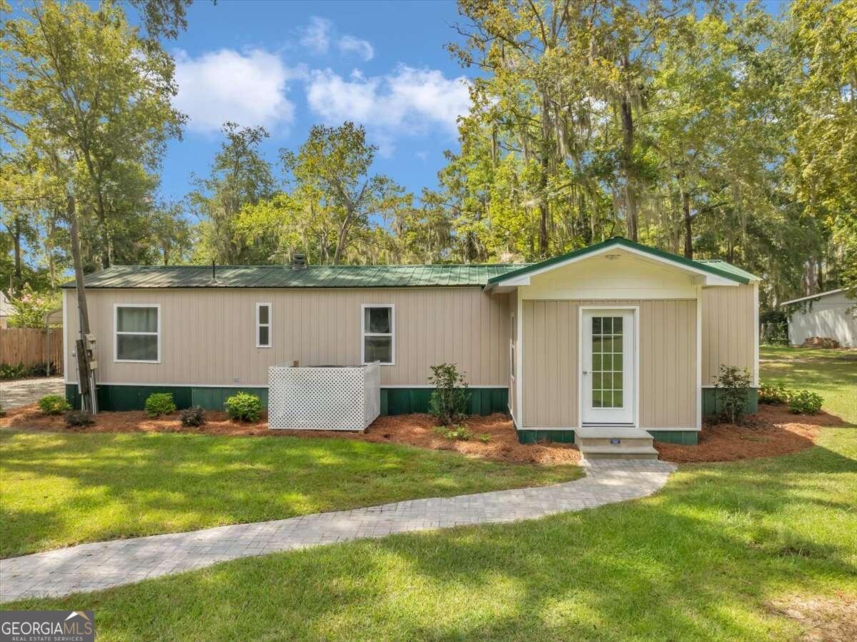 a front view of house with yard and green space