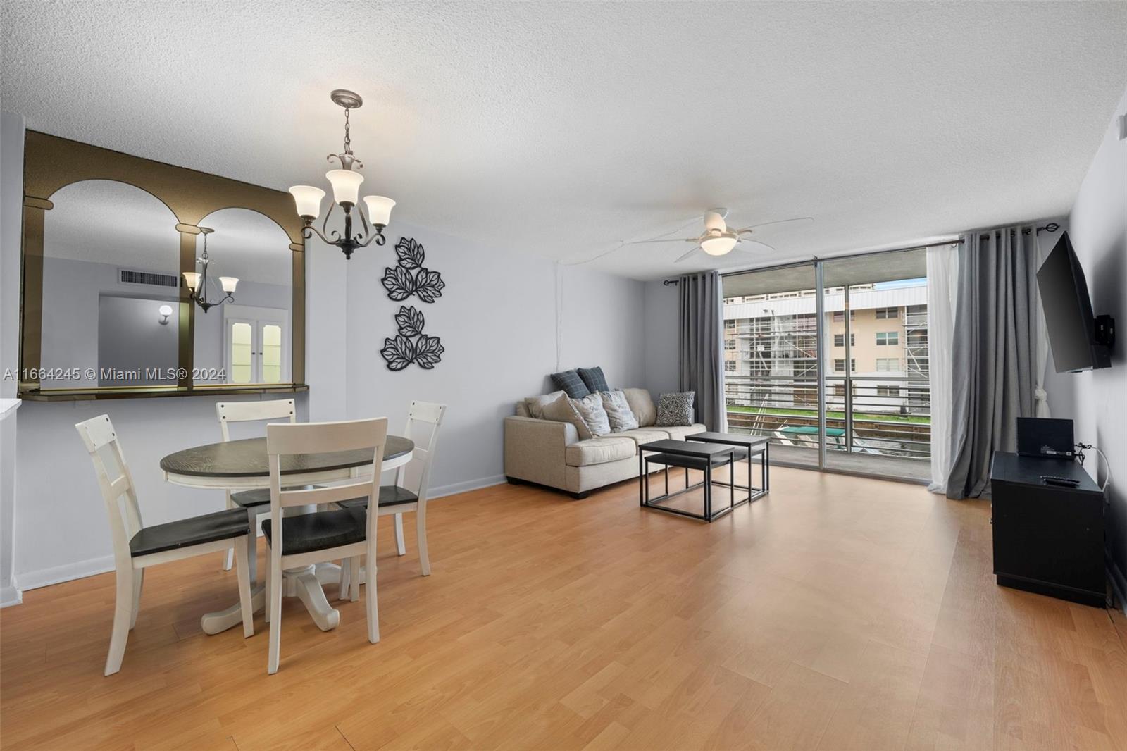 a view of a livingroom with furniture window and wooden floor