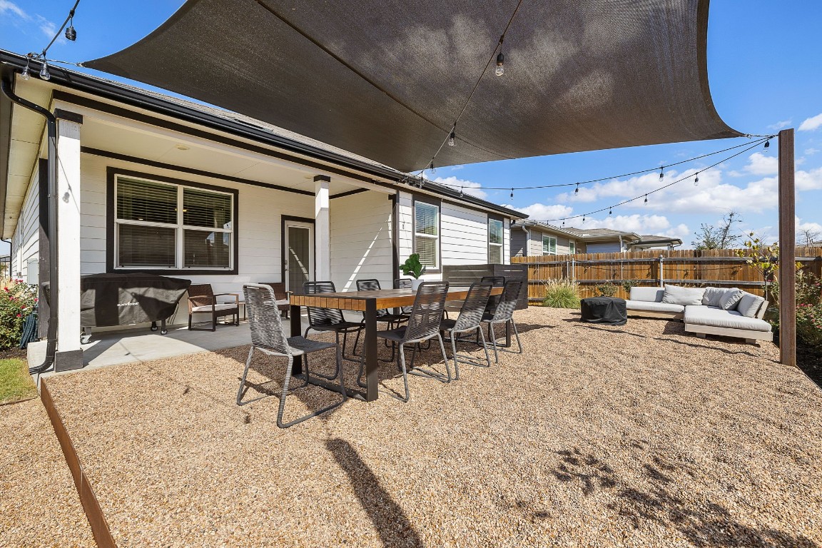 You will love this modern patio extension with metal edging, pea gravel and a sun shade.