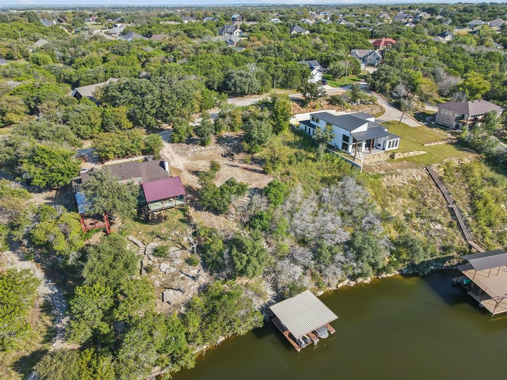 an aerial view of residential house with yard and swimming pool