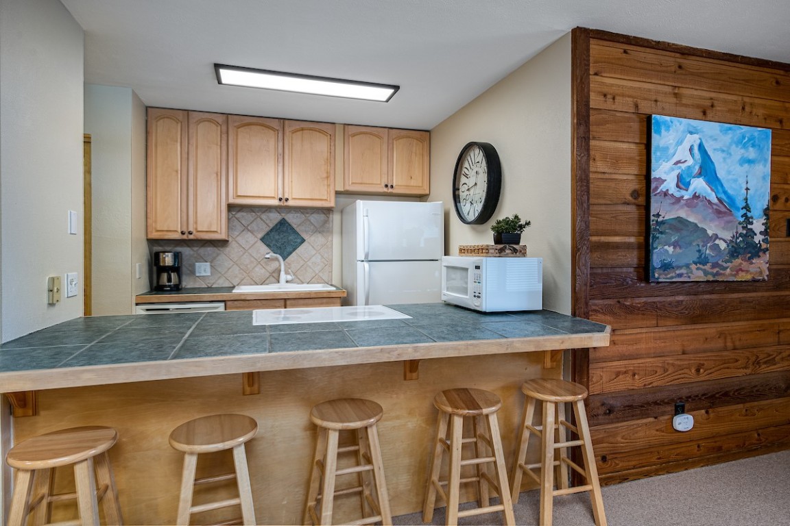 a kitchen with a table and chairs in it