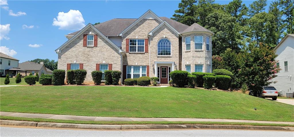 a front view of a house with a yard