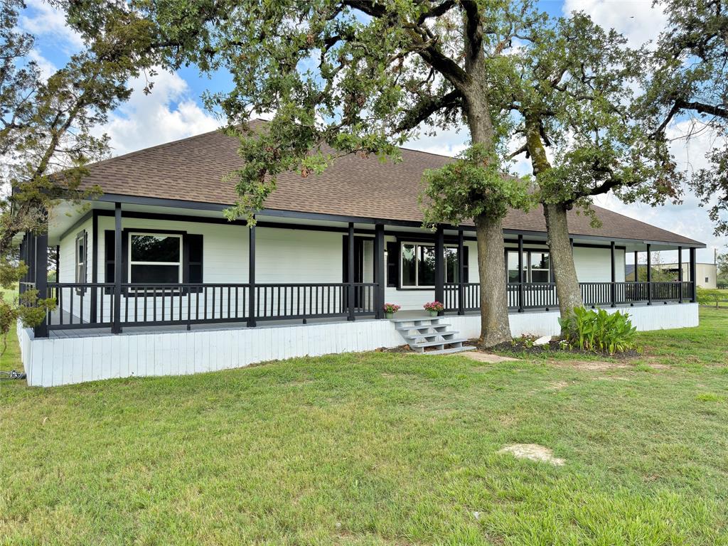 a front view of a house with a garden and yard