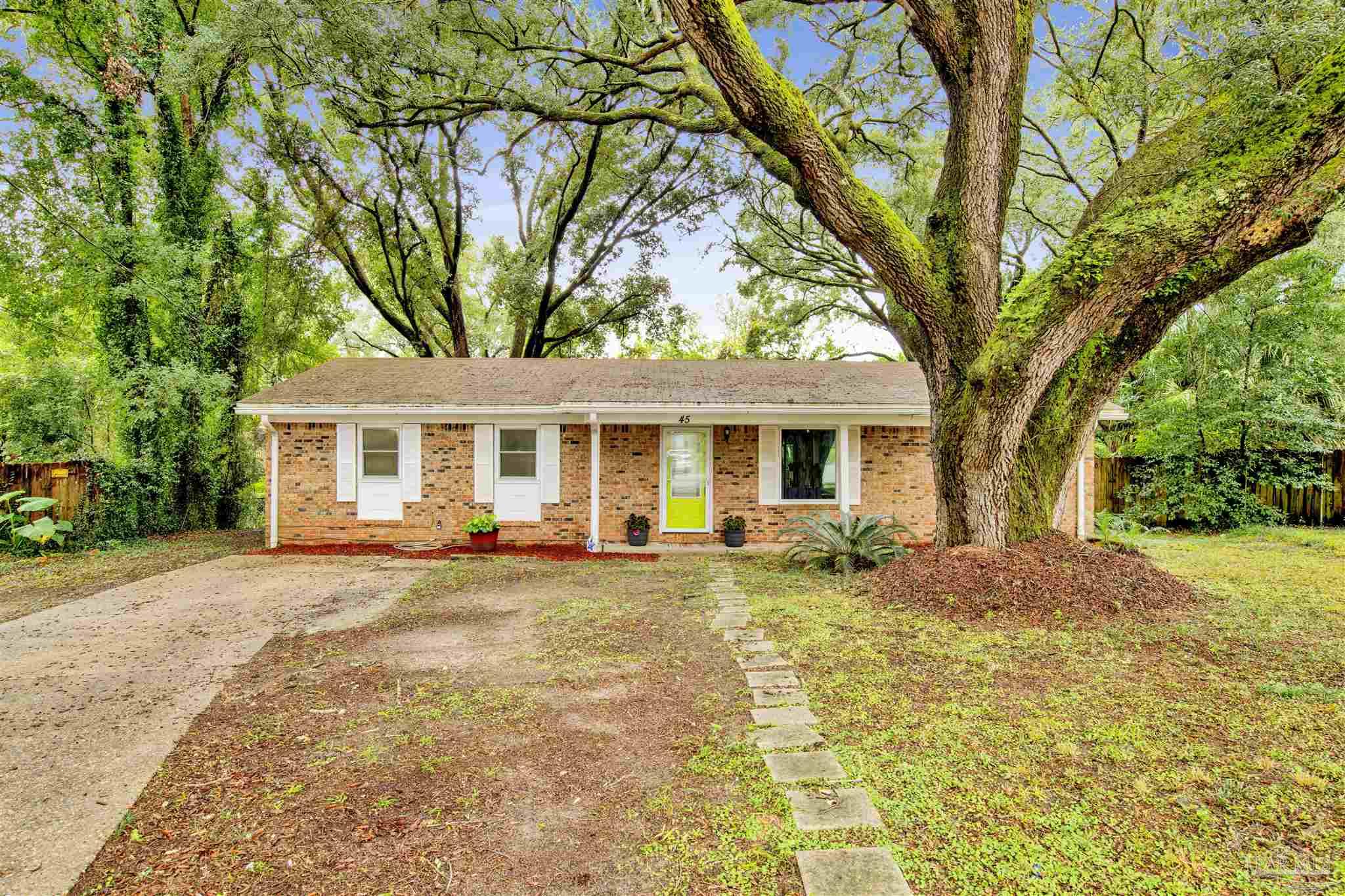 a front view of a house with yard porch and outdoor seating