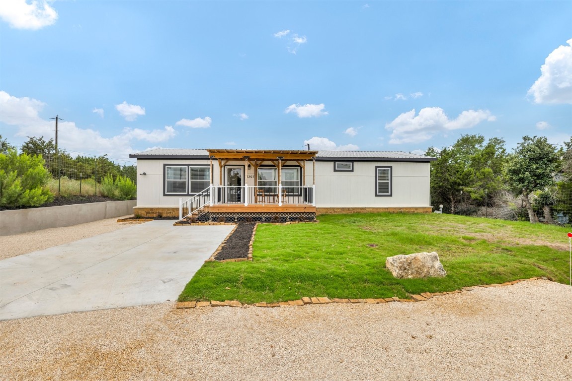 Situated on a .14-acre lot in one of the most sought-after neighborhoods in Dripping Springs, this like-new manufactured home exudes style and contemporary charm