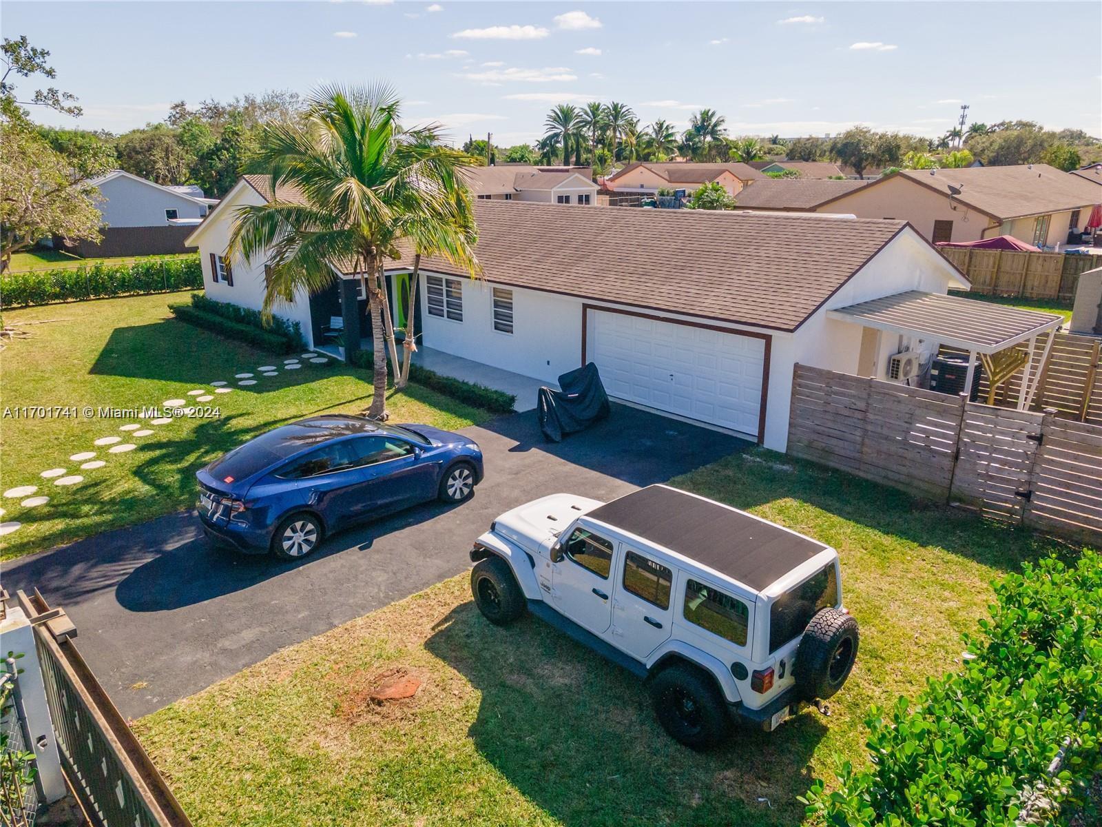 an aerial view of a house with swimming pool and ocean view