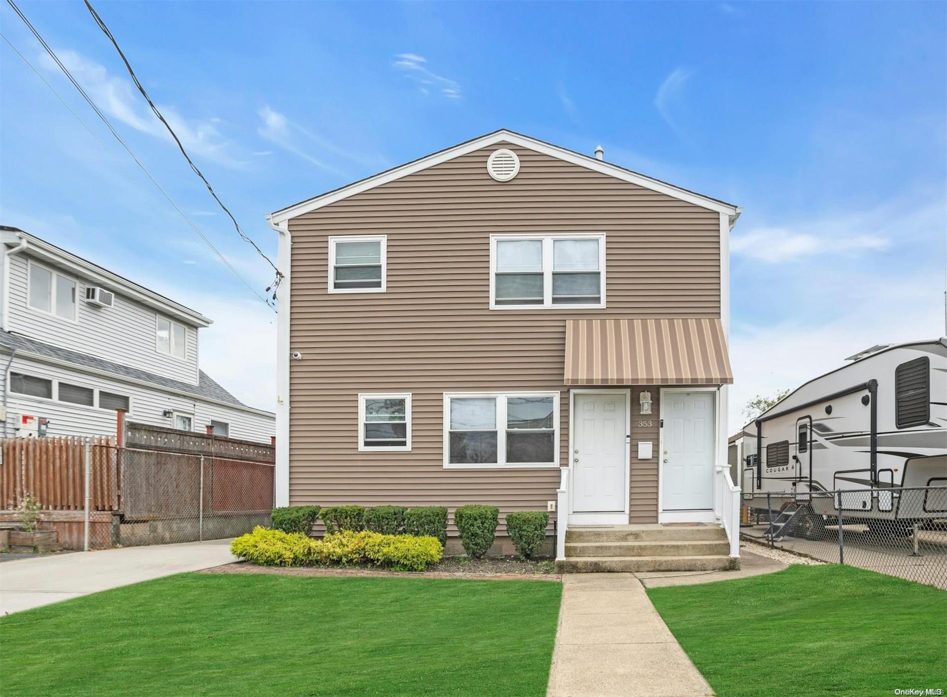 a front view of a house with a yard