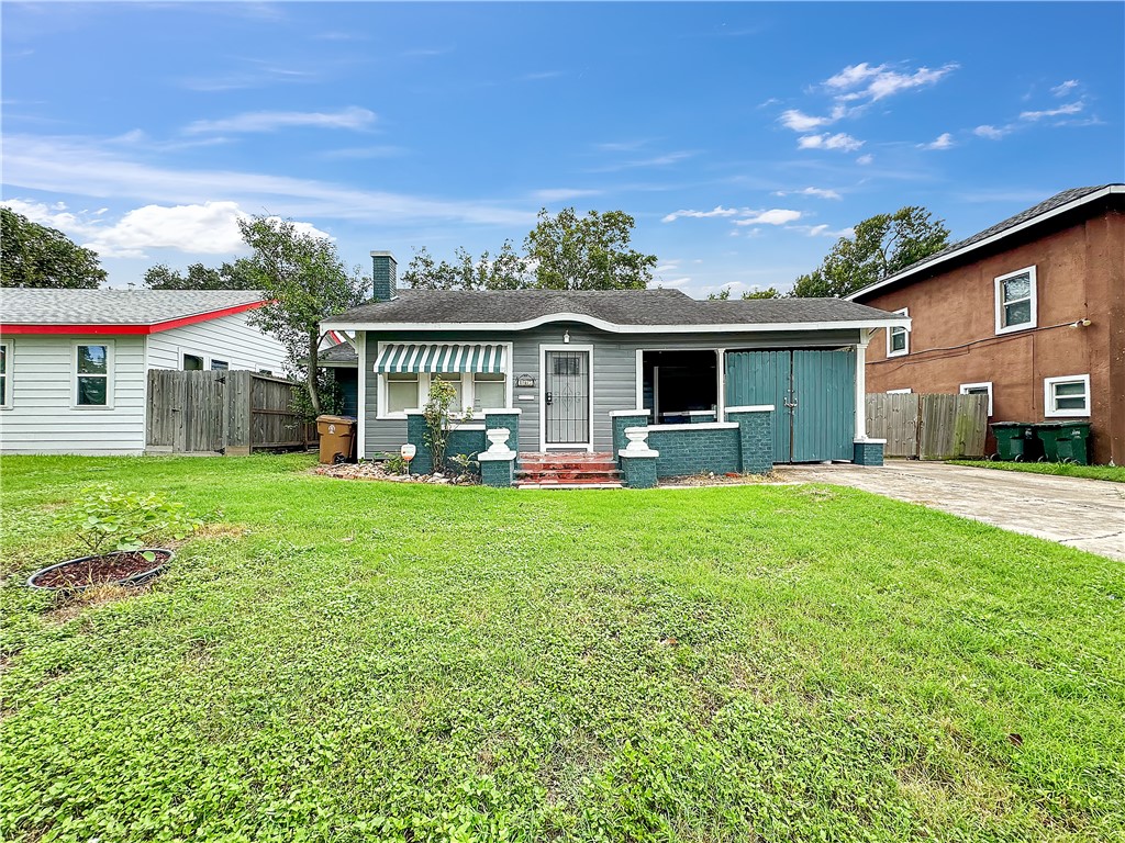 a front view of house with yard and outdoor seating