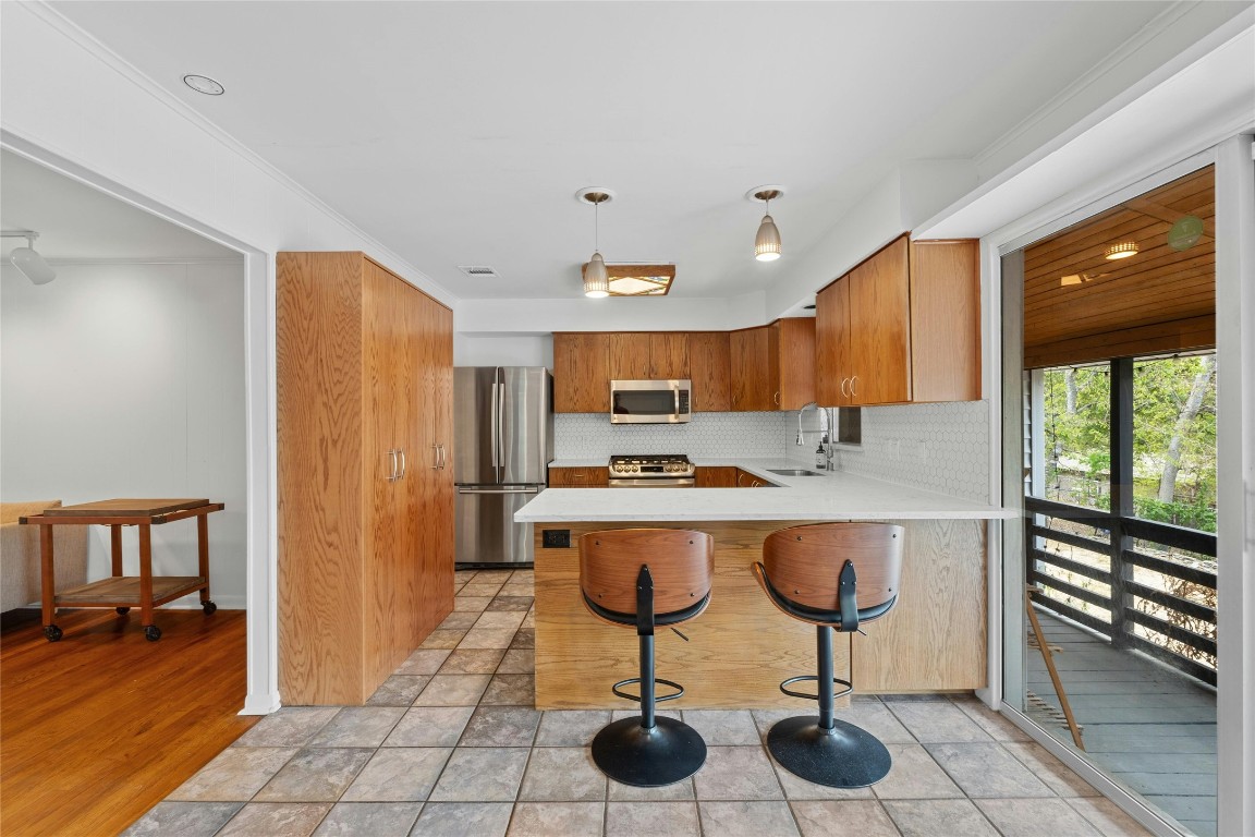 a view of kitchen with kitchen island dining table and a large window