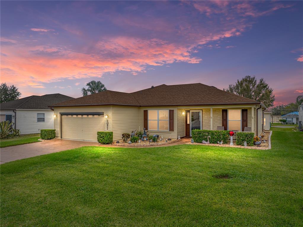 a front view of a house with a yard and garage