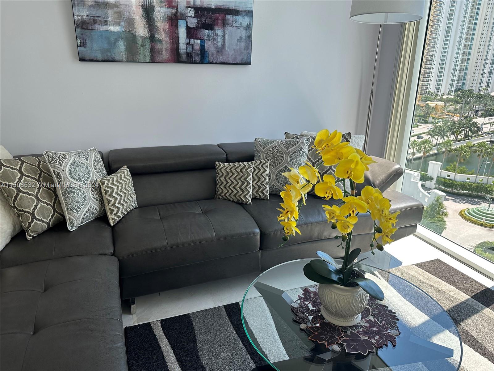 a living room with furniture and flowers