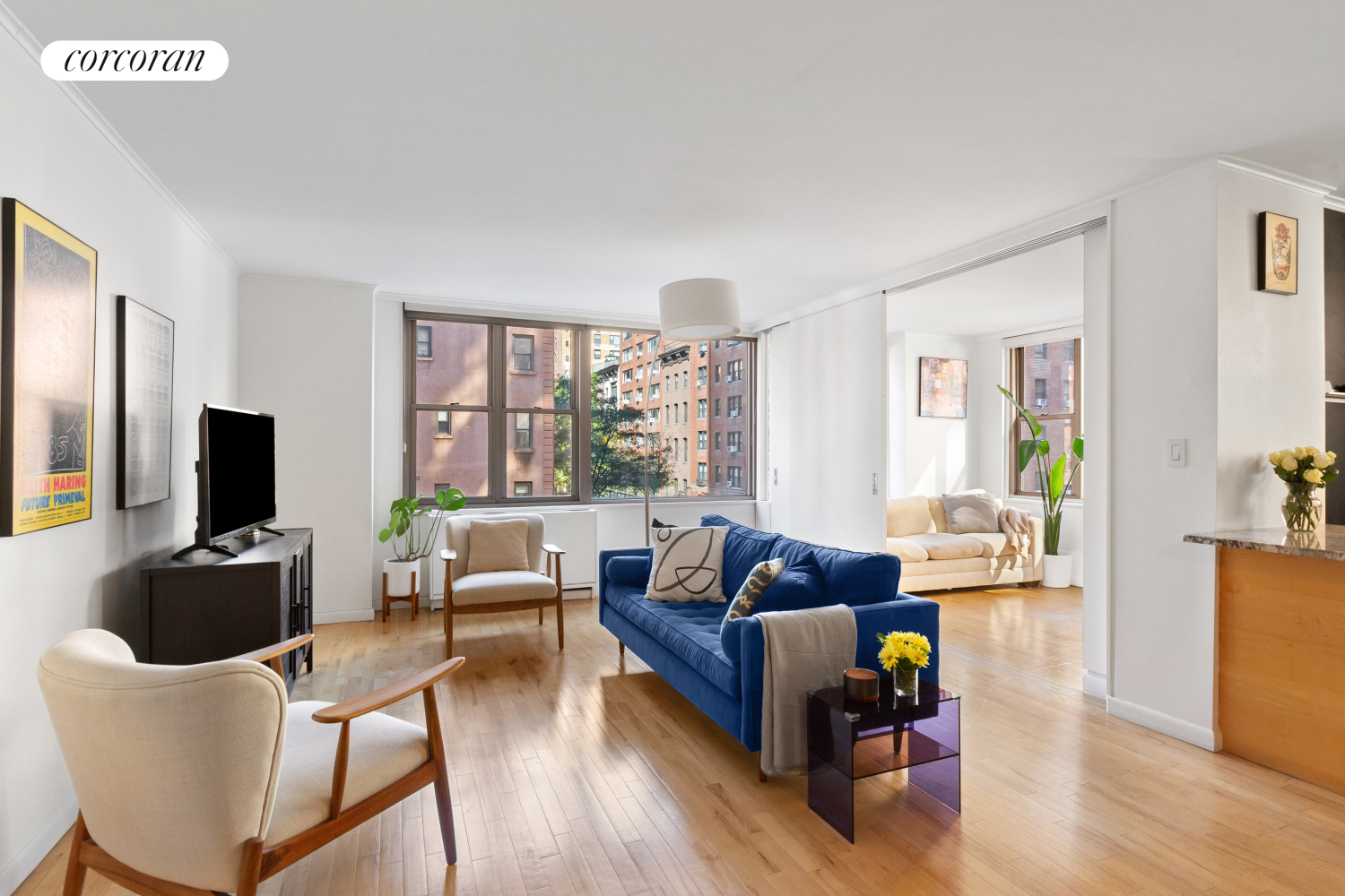 a living room with furniture a flat screen tv and a large window