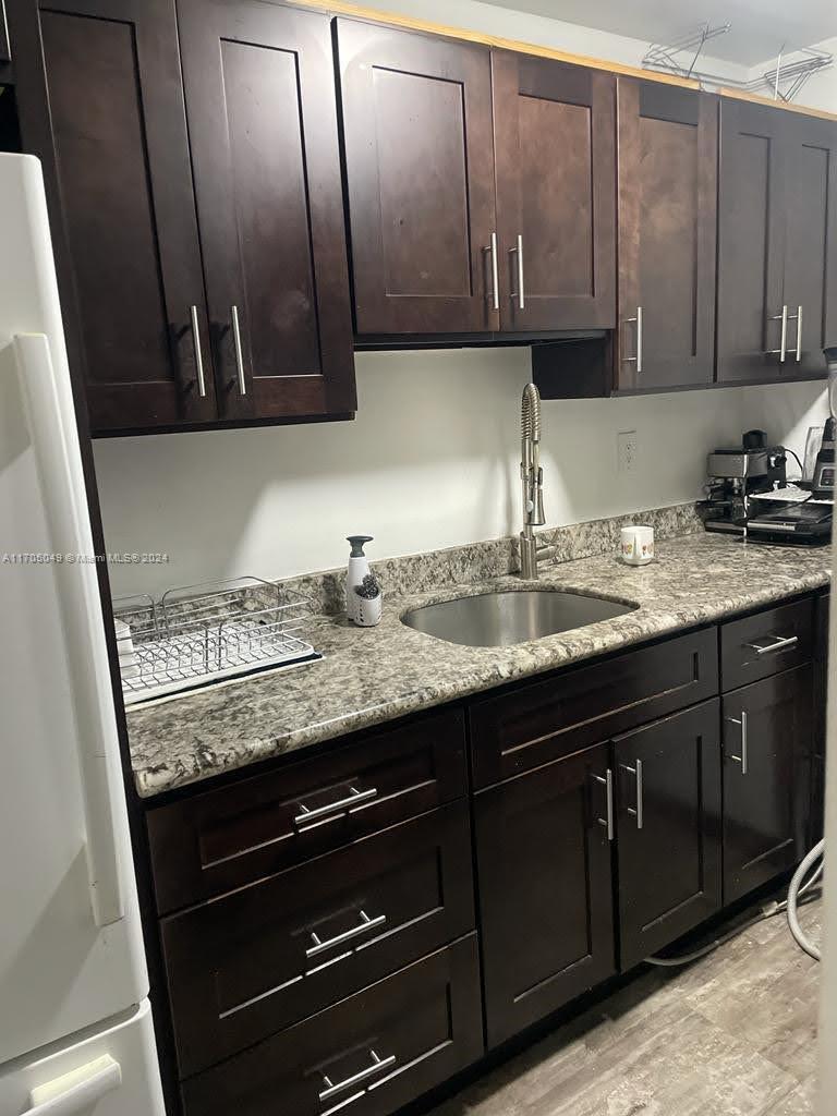 a kitchen with granite countertop cabinets and a sink