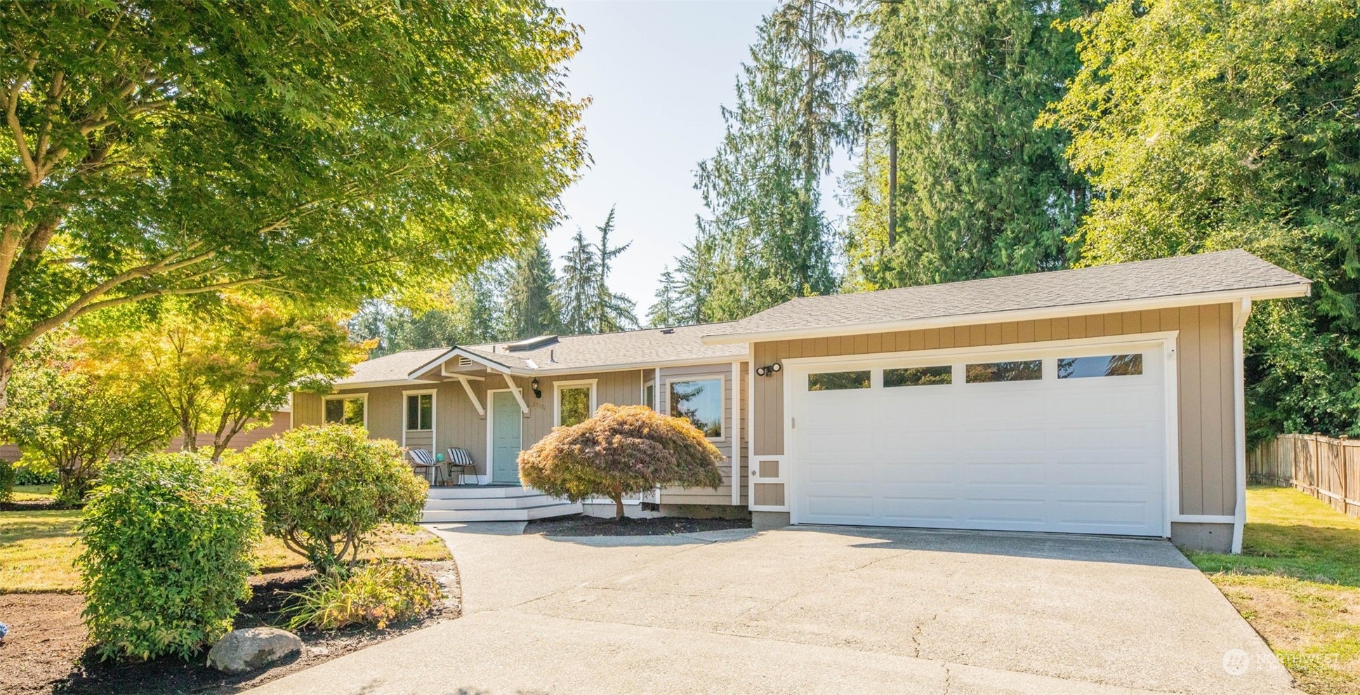 a view of a house with a yard and a garage