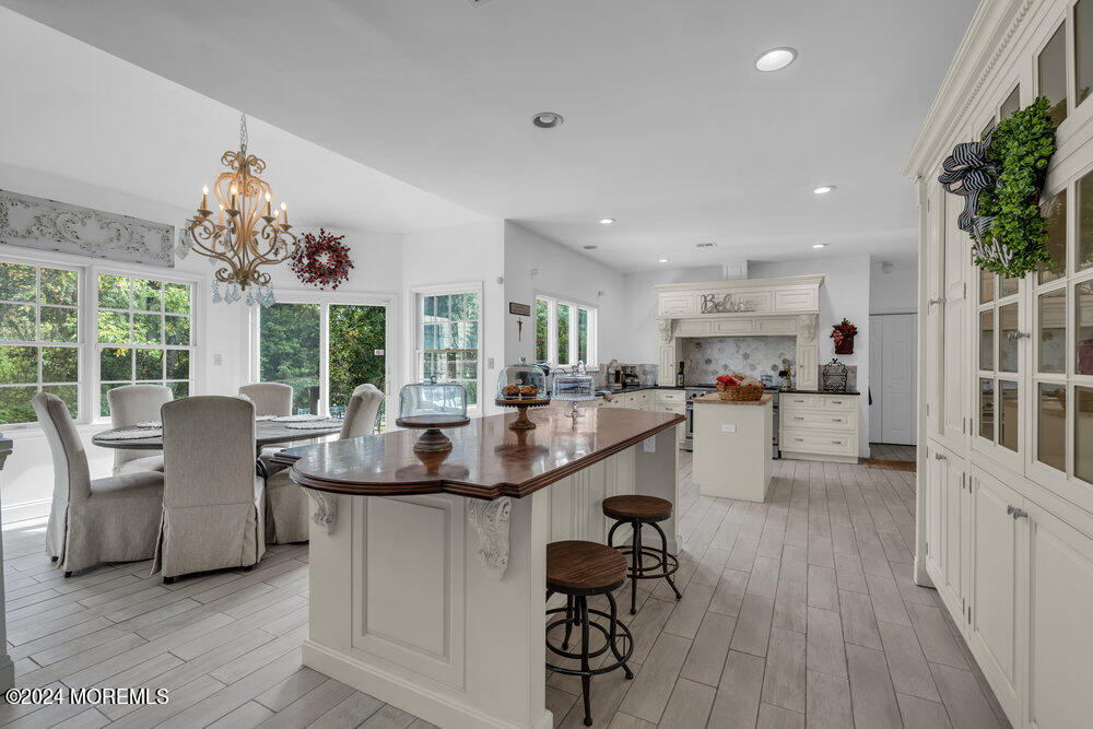 a kitchen with counter space dining table and chairs