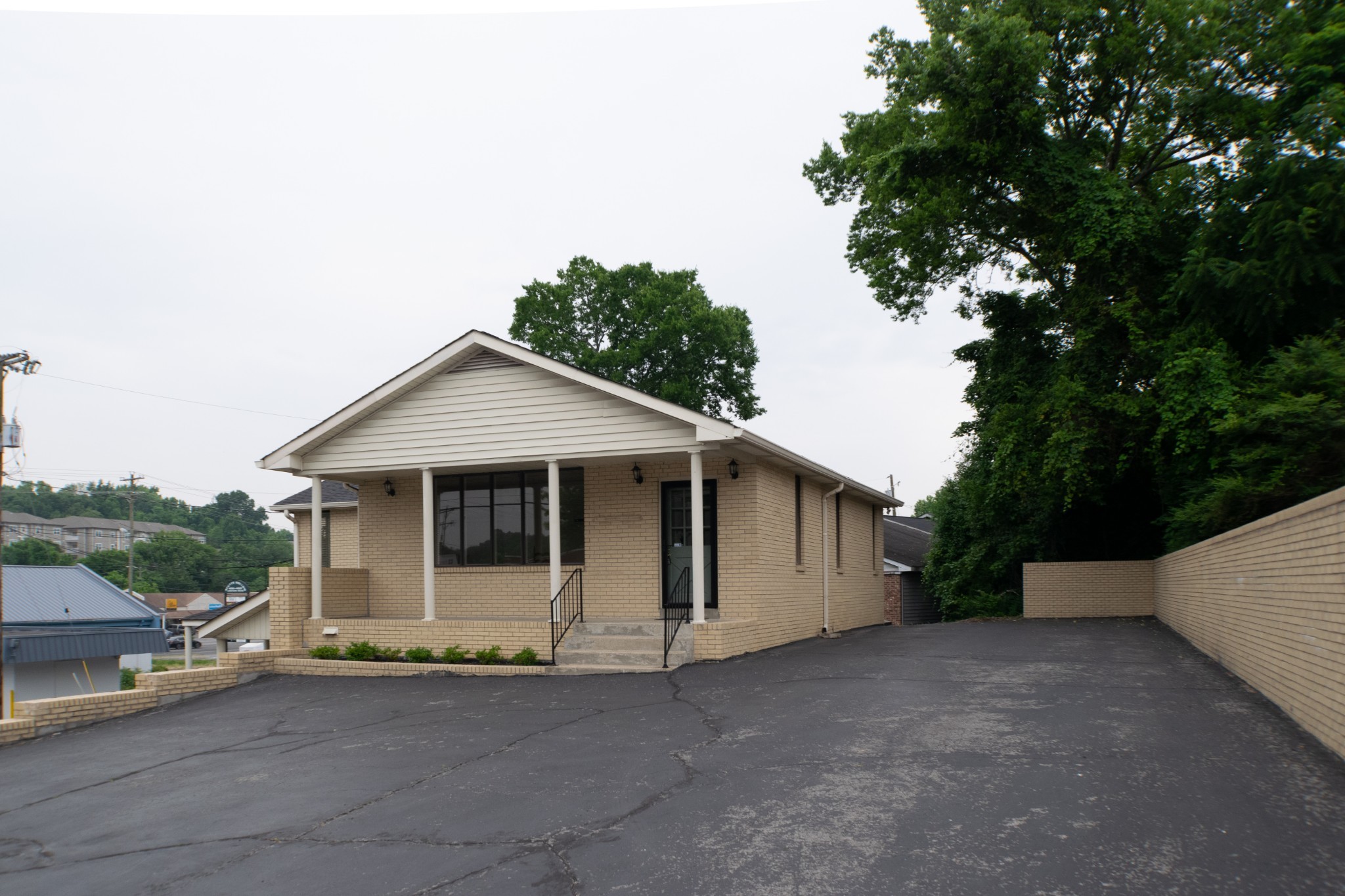 a view of a house with a backyard and trees