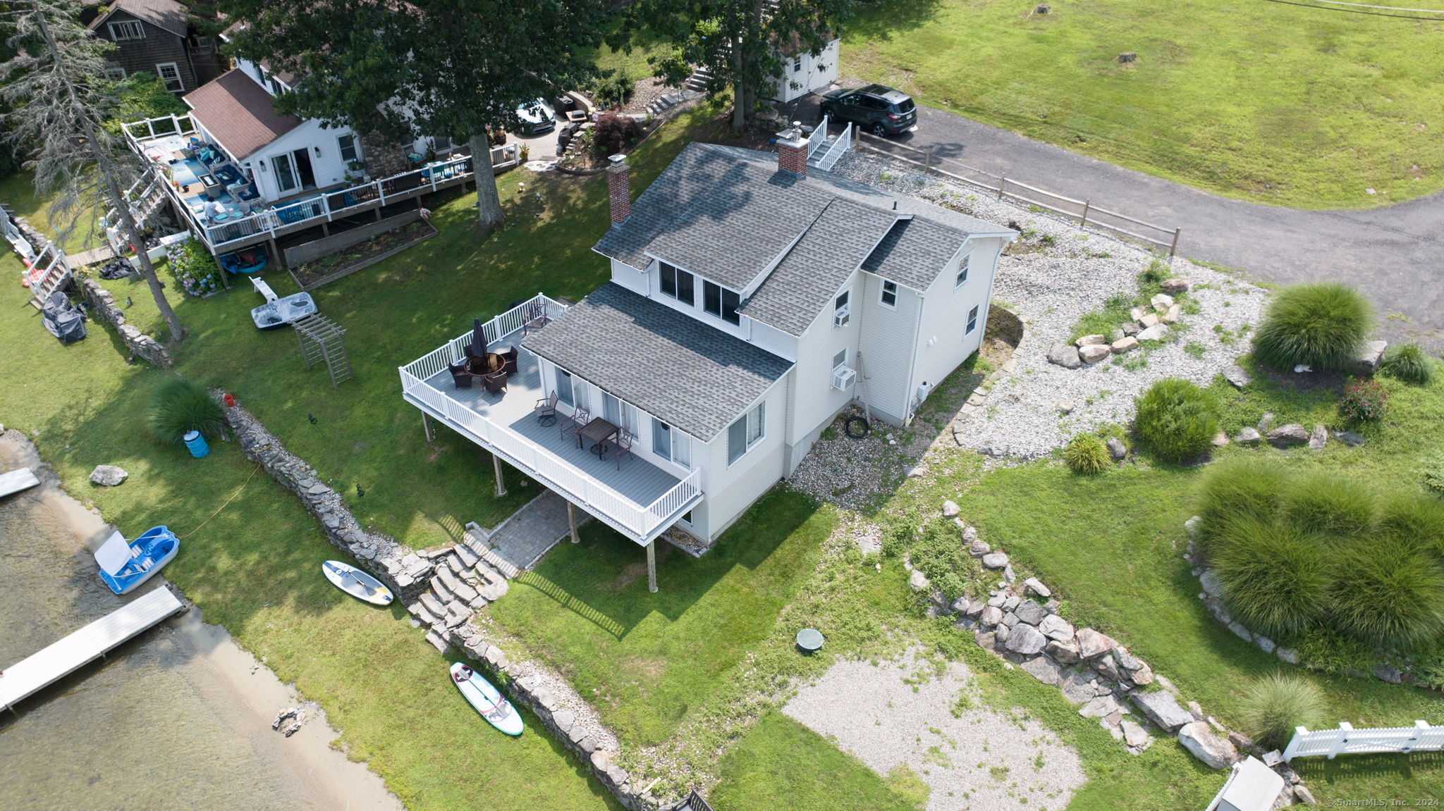 an aerial view of a house with a garden and lake view