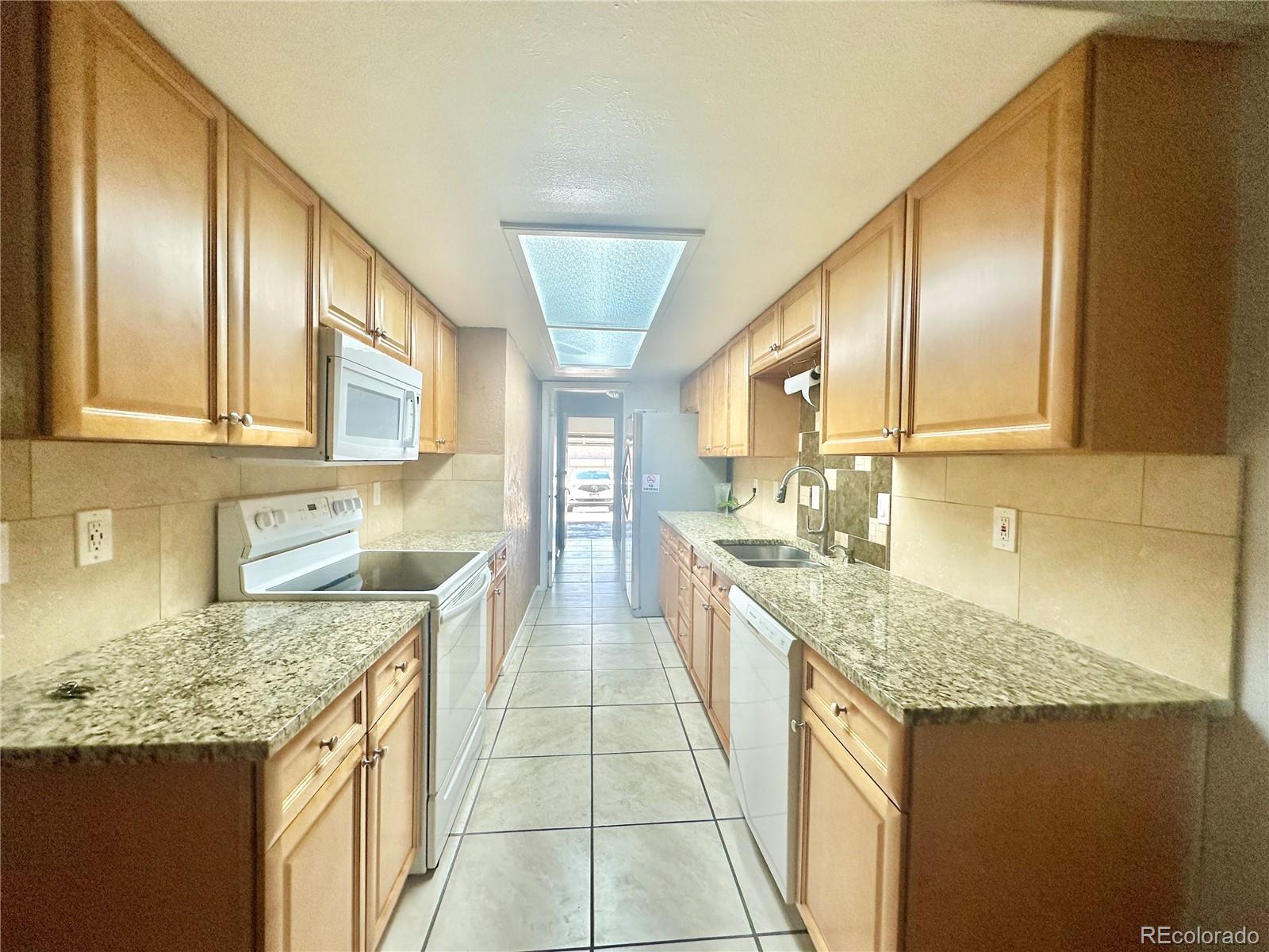 a kitchen with stainless steel appliances granite countertop a sink and cabinets