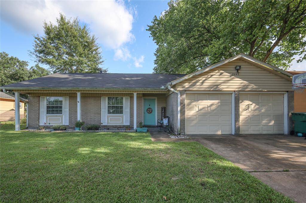 a front view of a house with a yard and front view of a house