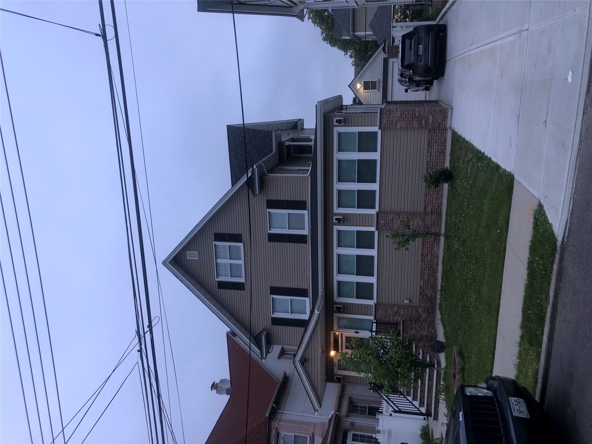 View of front of home featuring an outbuilding and a garage