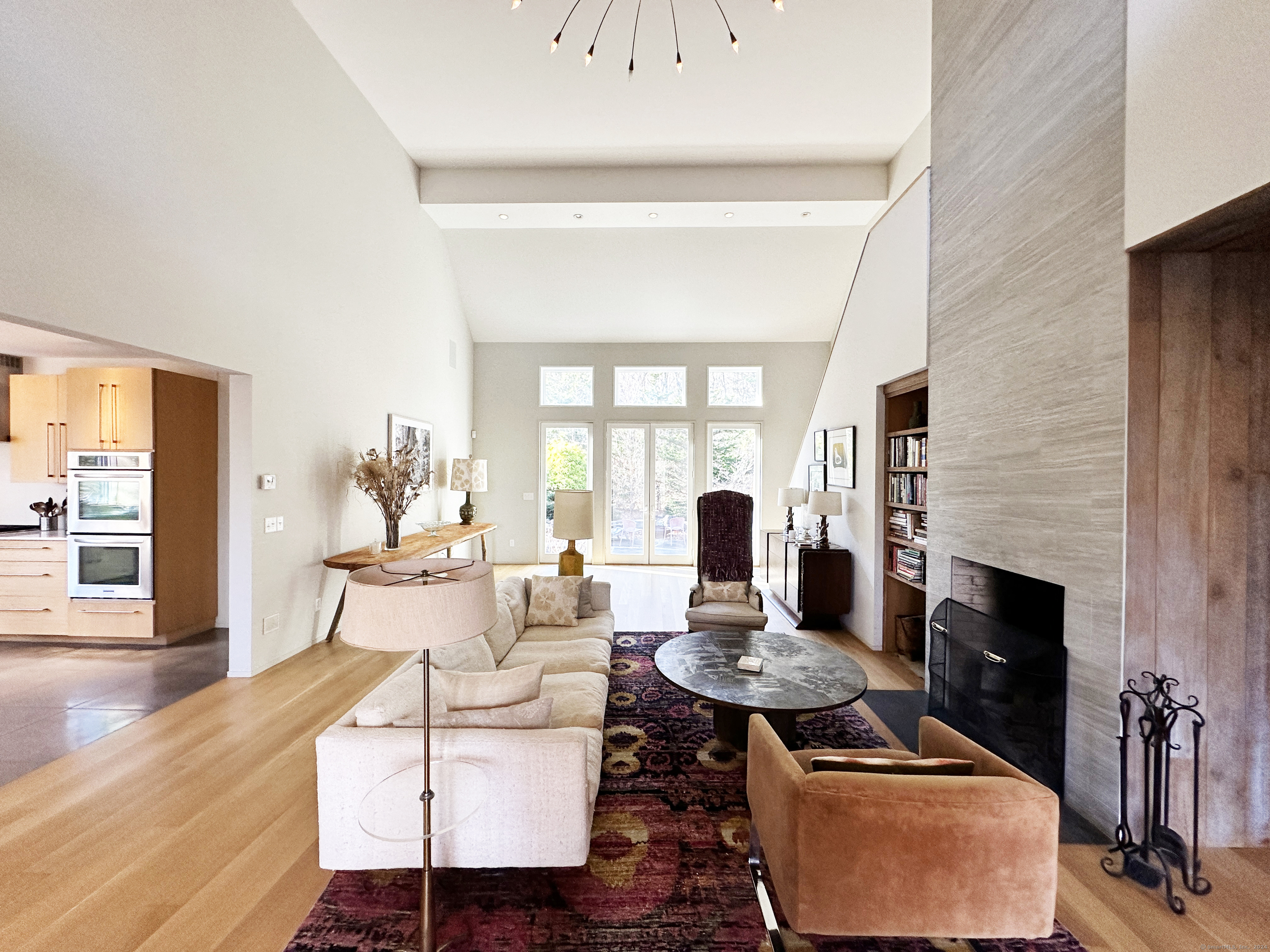 a living room with furniture fireplace and wooden floor