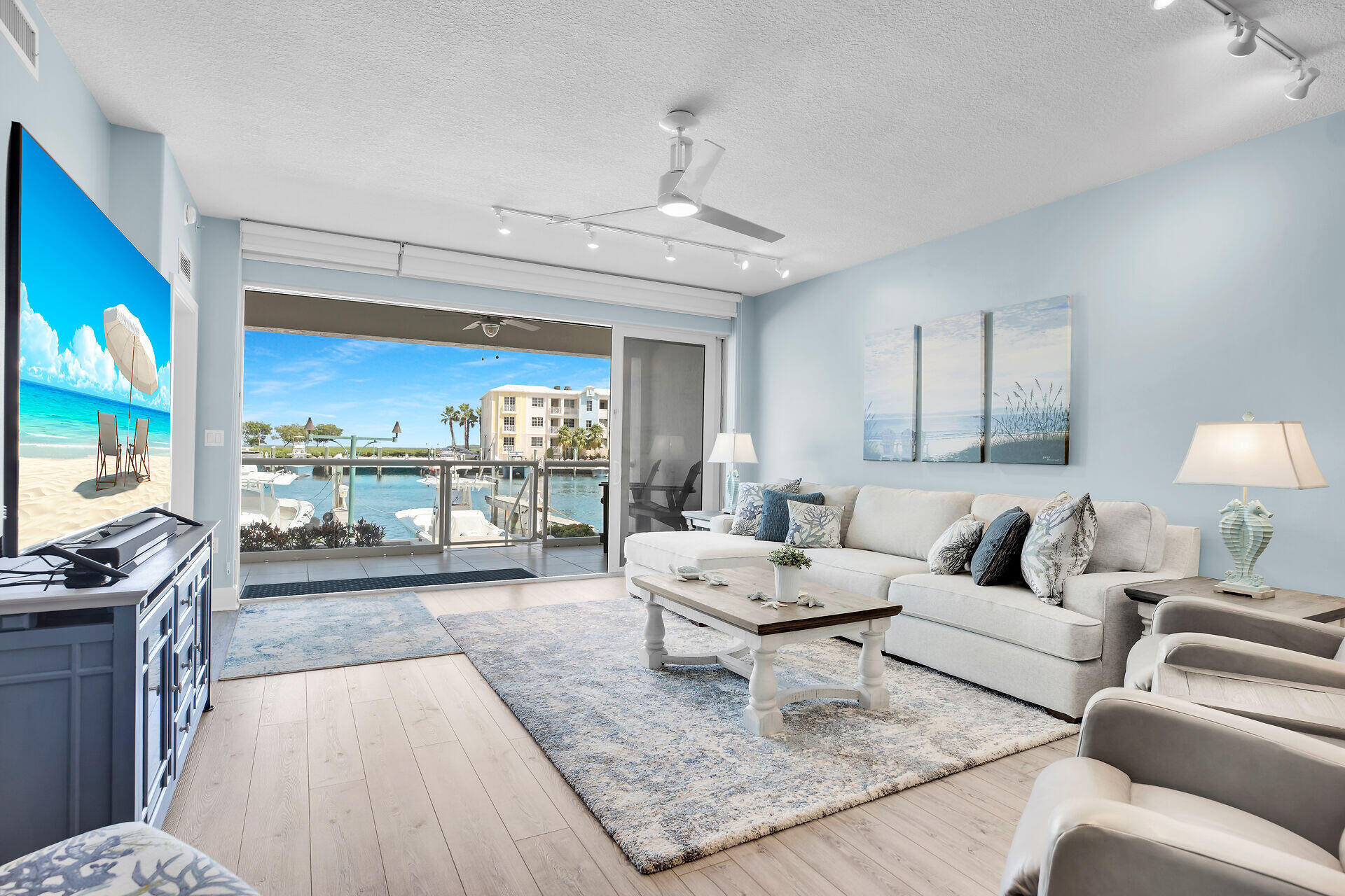 a living room with furniture large window and flat screen tv