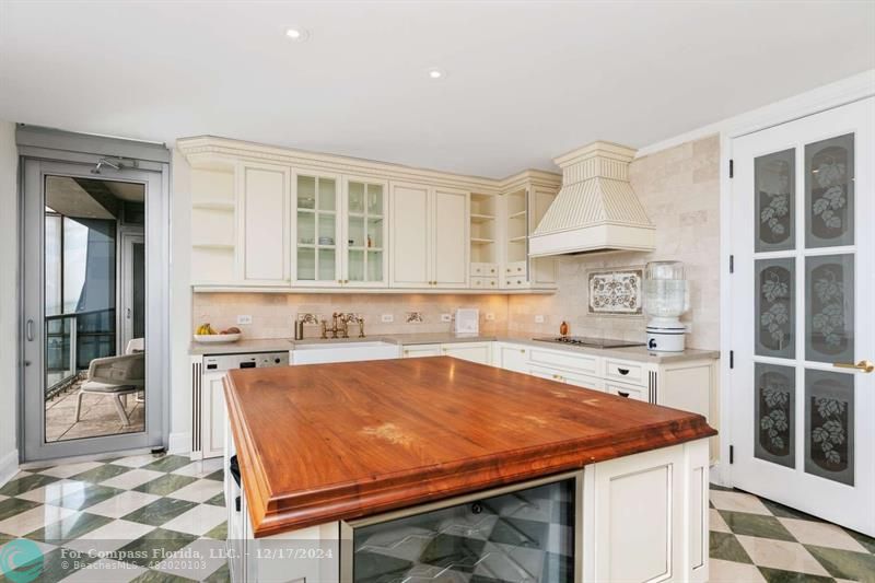 a kitchen with a stove a sink and a refrigerator