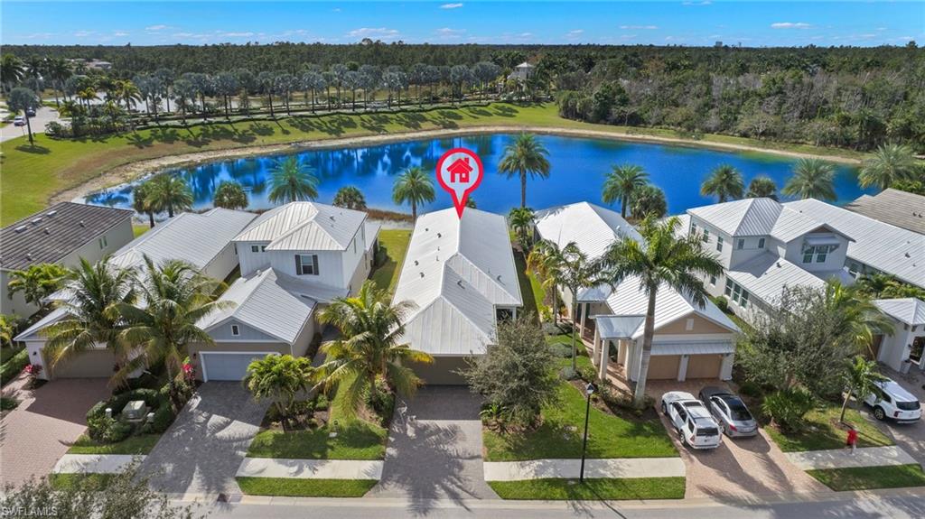 an aerial view of house with swimming pool and lake view