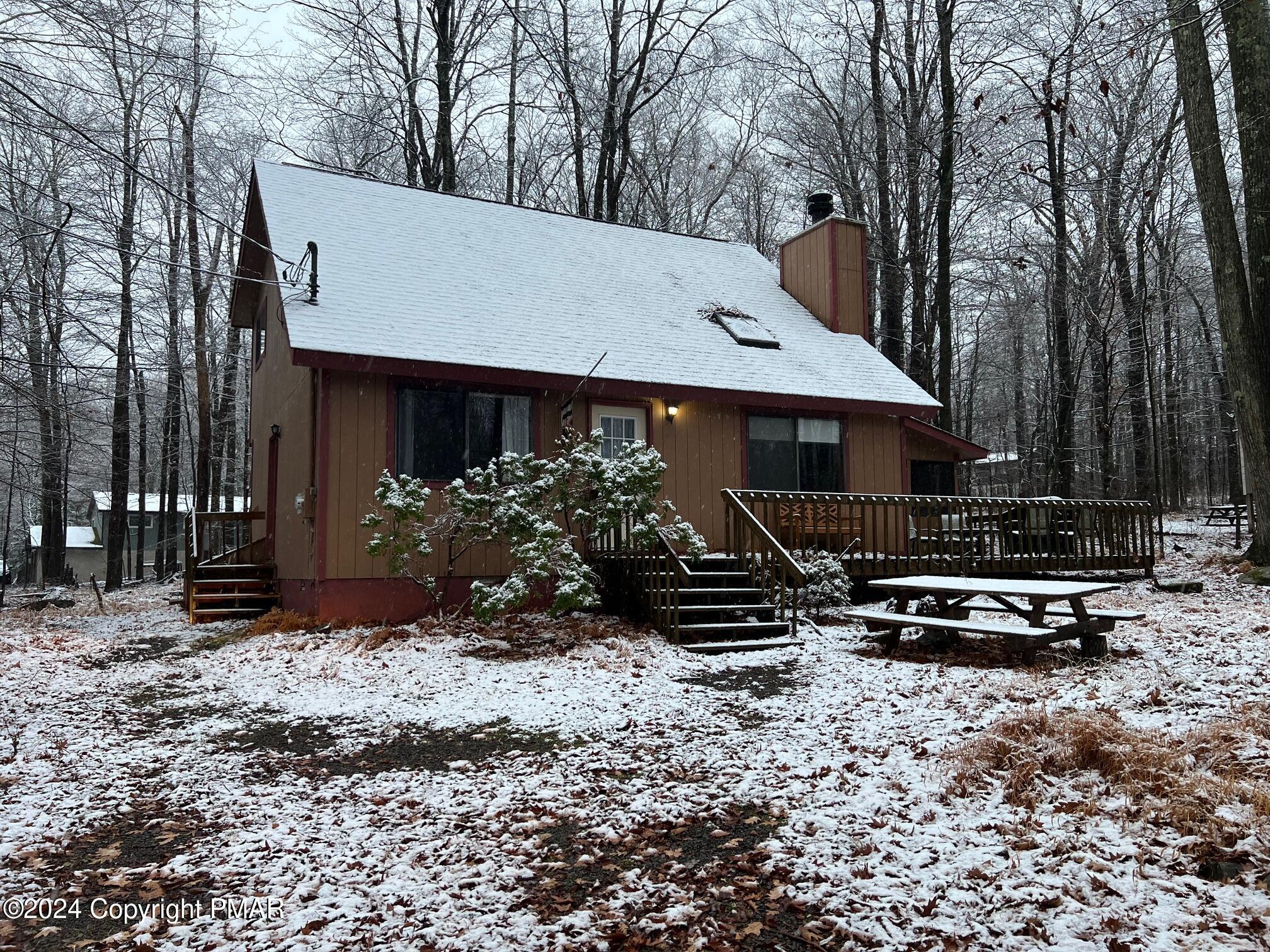 a front view of house with yard outdoor seating and barbeque oven