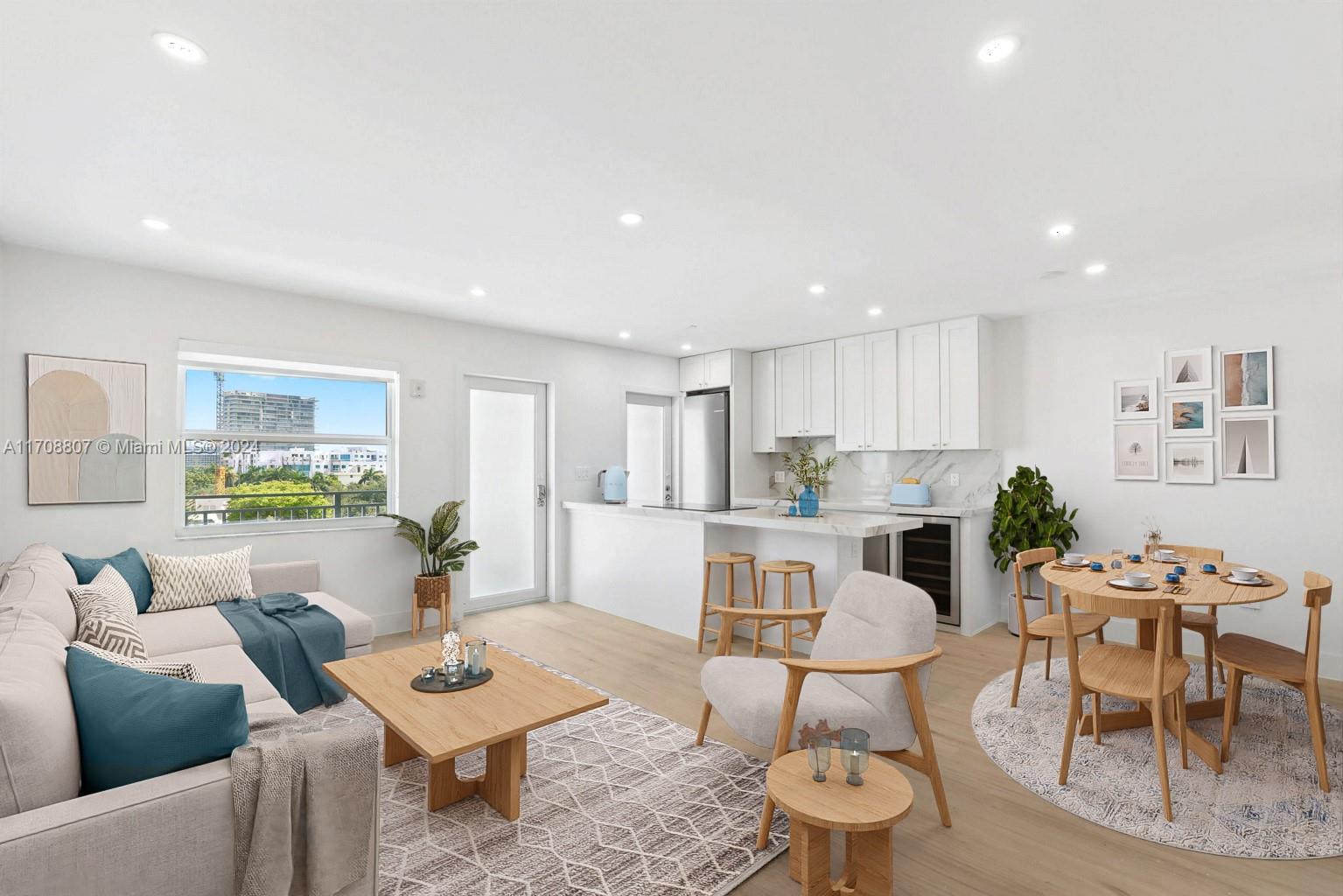 a living room with furniture and a dining table with kitchen view