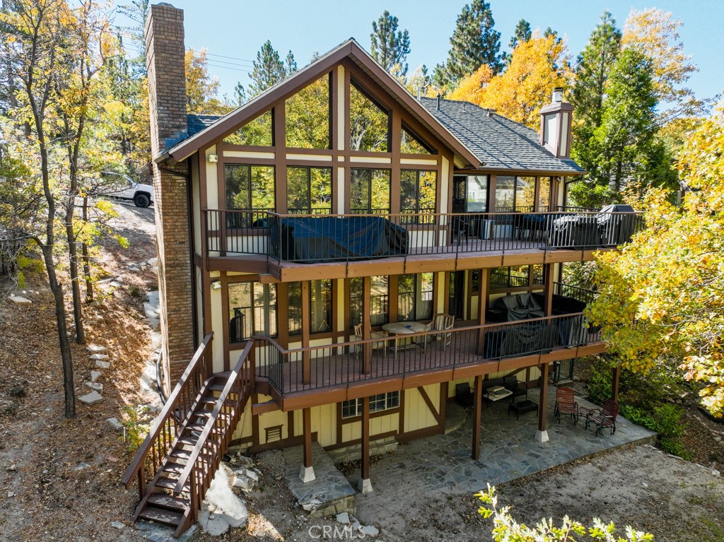 a view of a house with a yard and wooden deck