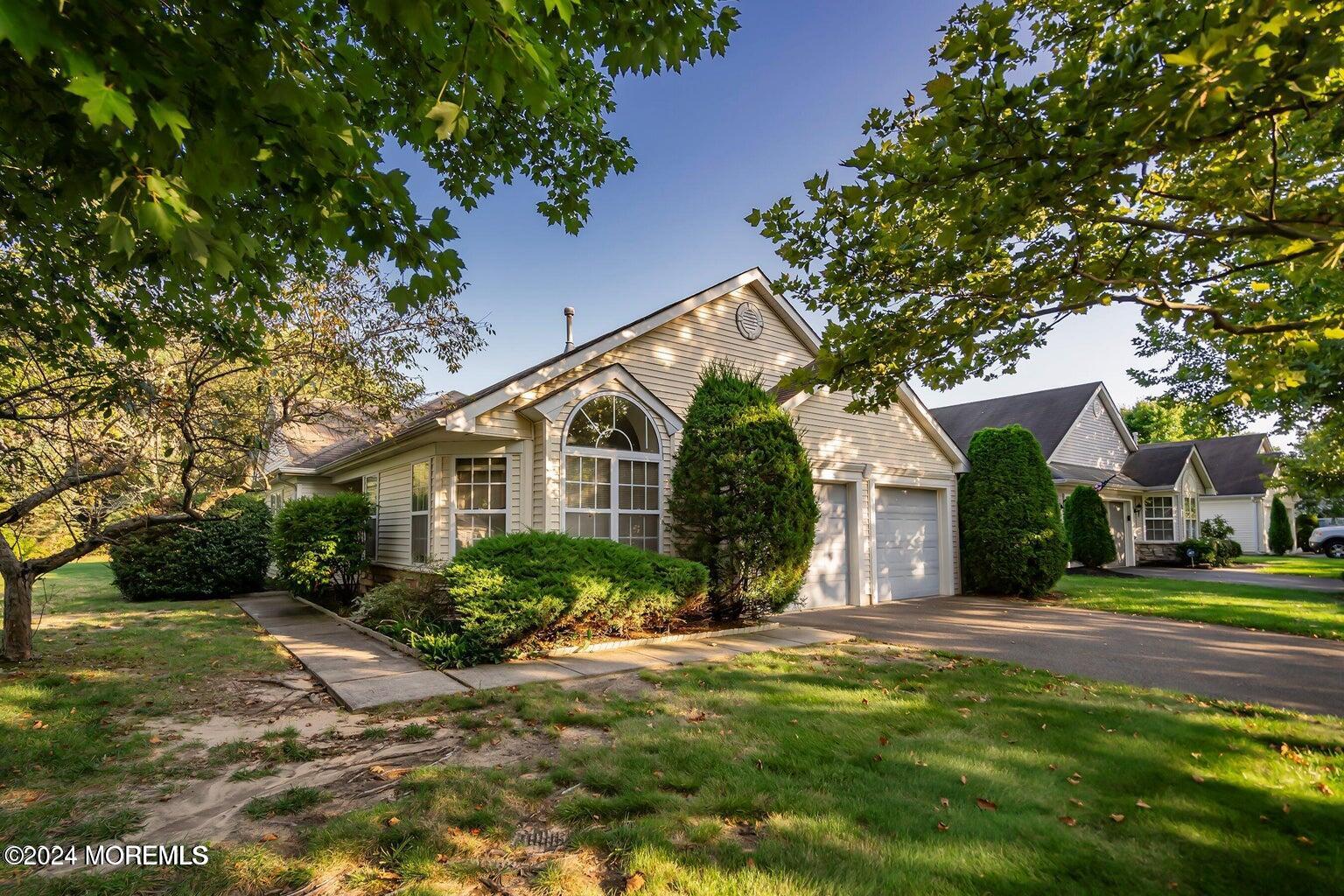 a front view of house with yard and green space