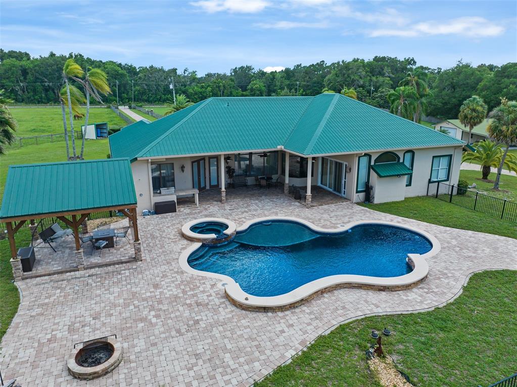 an aerial view of a house with swimming pool garden and patio