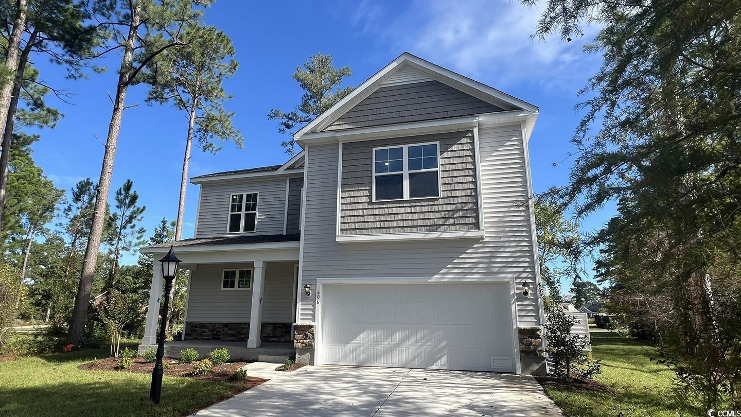 View of front of house featuring a garage and a fr