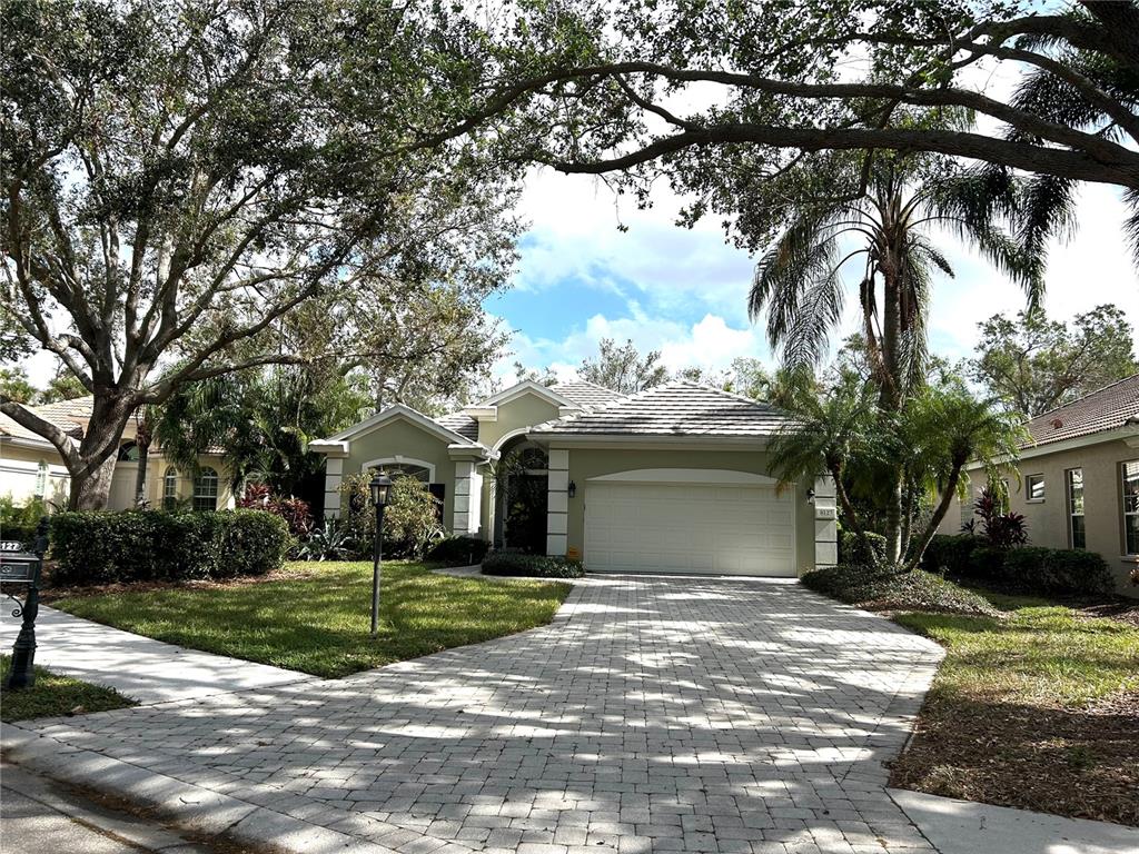 a front view of a house with a yard and garage