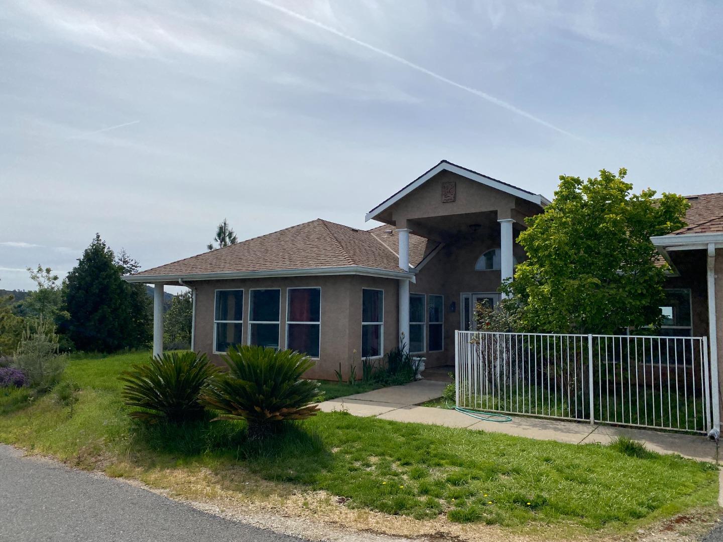 a front view of a house with a garden