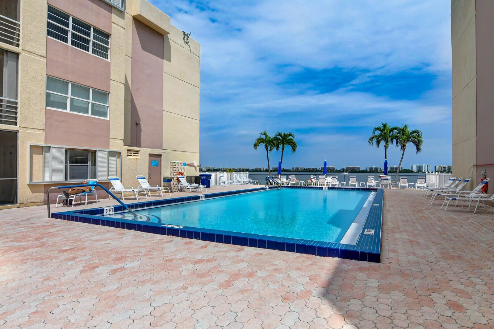 an outdoor space with swimming pool and furniture